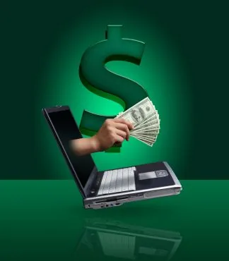 Hand holding cash emerging from a laptop screen on a green background